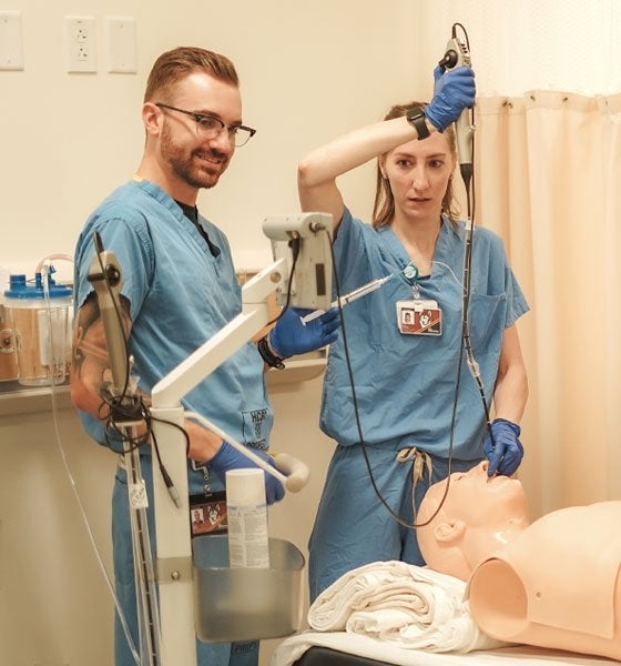 Nurse Anesthetists performing a procedure on a dummy.