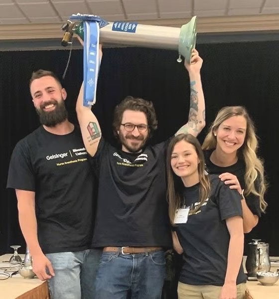 BU's winning team members:  left to right: Matthew Moore, Matthew Homishak (holding oxygen tank trophy), Ciana Rollman, Elise Slaughter (in back).