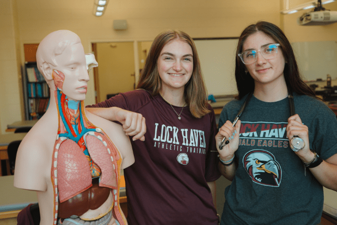 Two Athletic Training students at CU-Lock Haven pose with medical mannequin