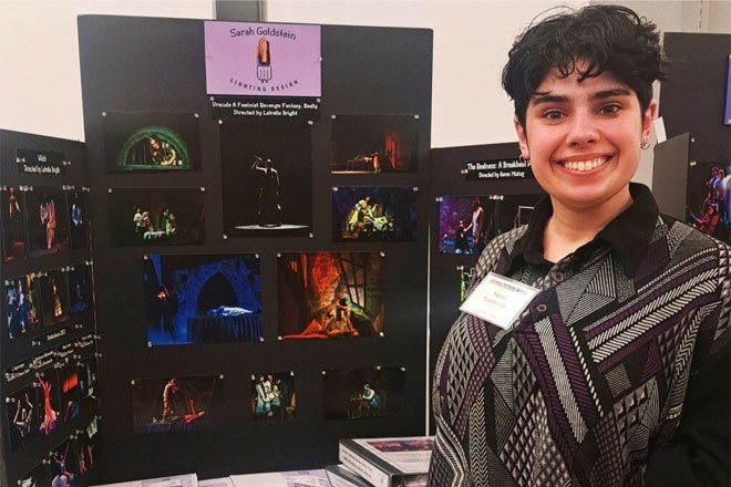 Sarah Goldstein, '22 Theatre Arts, poses in front of her lighting design presentation