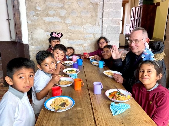 Dr. Steven Granich eating lunch with students at Education and Hope.