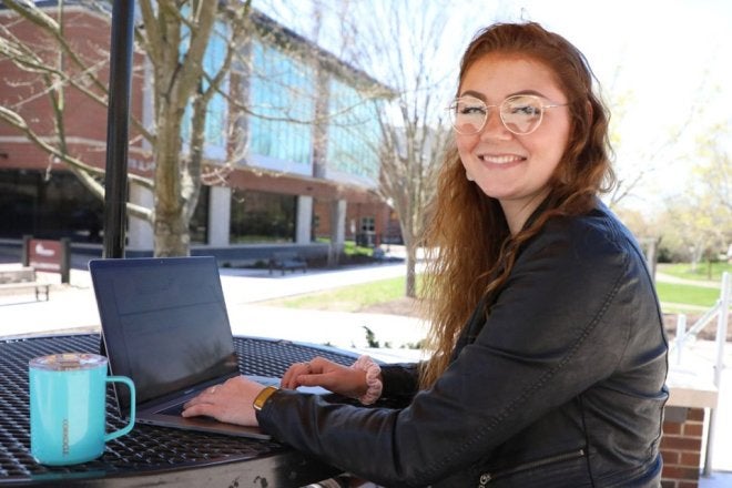 Graduate student studying outdoors