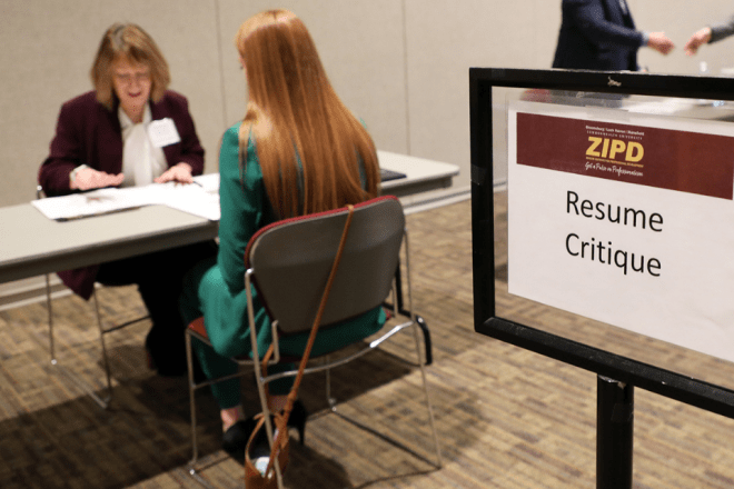Alumni volunteer, Diane Brennan reviews a students' resume at a recent ZIPD Conference