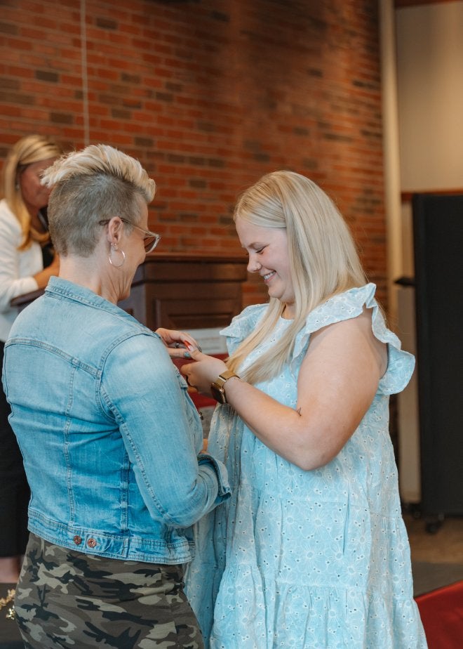 CU-Mansfield student receives her pin during the teacher induction and pinning ceremony.
