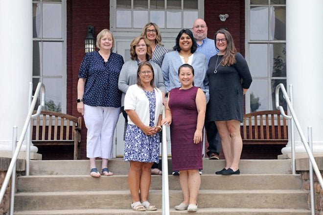 Alumni and Profession Engagement team on Carver Hall steps.