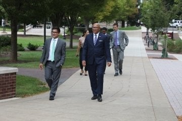 Pennsylvania Auditor General, DeFoor (right) walks through the BU campus with Dan Knorr,&nbsp;Director of External and Government Relations (left). Hayden Rigo is pictured back right.