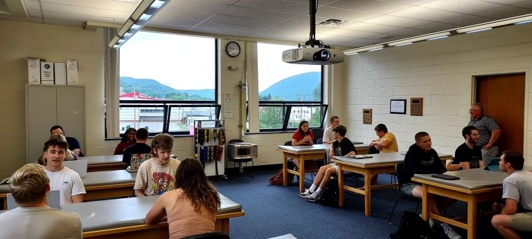 Group of students sitting together at tables.