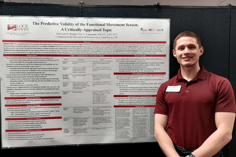 A man standing by an information sign.