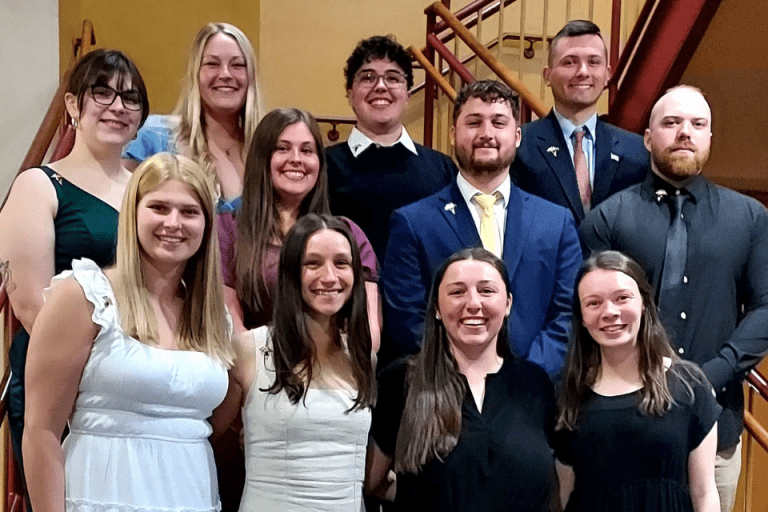 A group of people standing together for a photo. 