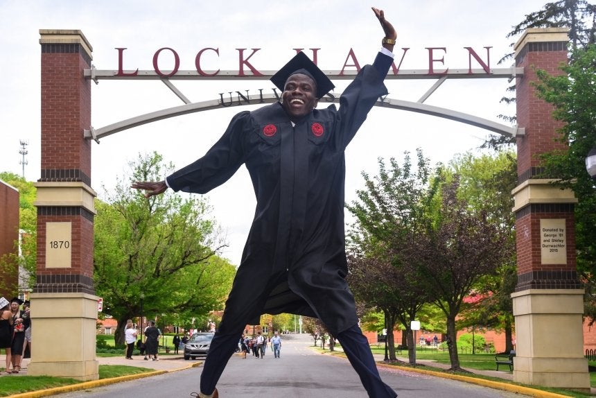 A man jumping for joy after graduating. 