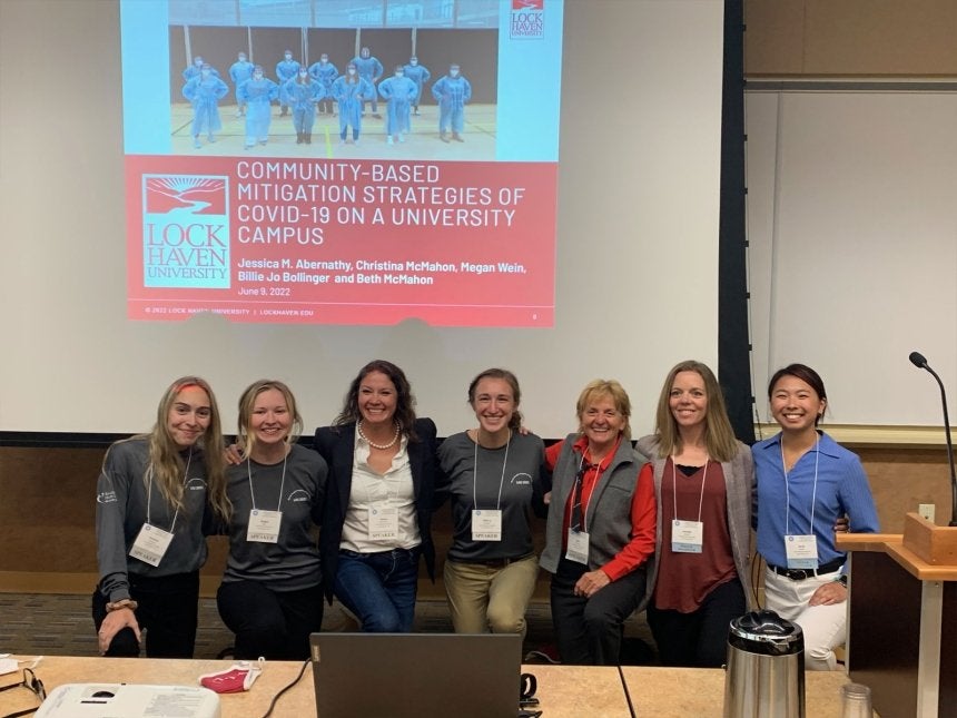 A group of people standing for a photo. 